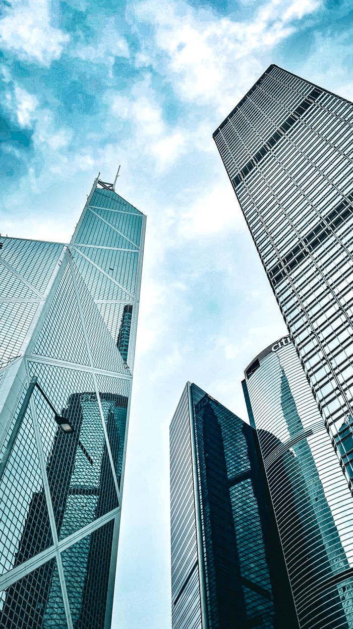 About Uplifting view of modern skyscrapers on Hong Kong Island against a blue sky.